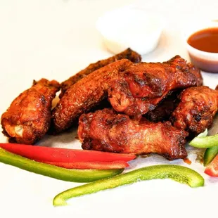 a plate of chicken wings and vegetables