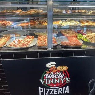 The wide selection of pizzas by the slice.