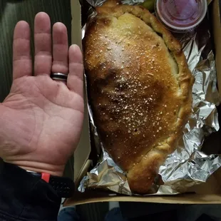 Bomb ass calzone. It's a large. Delicious and massive.