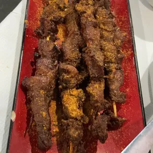 eef skewers on a red plate