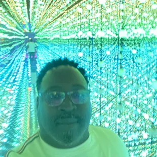 a man in front of a wall of lights