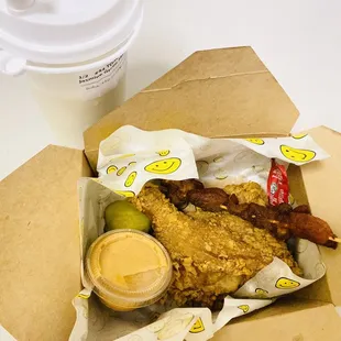 a box of fried chicken and a cup of coffee