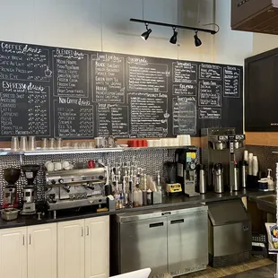 a coffee shop with menus on the wall