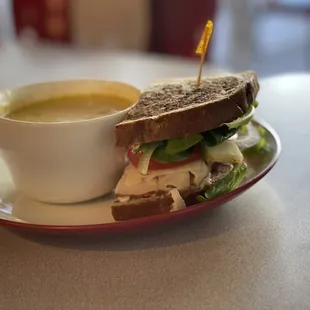 1/2 sandwich of turkey, swiss, apple, tomato, lettuce and a bowl of potato soup