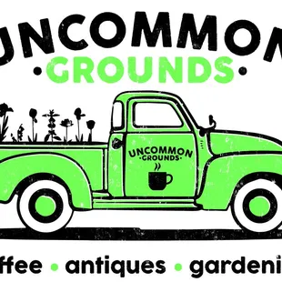 a green truck with flowers in the bed