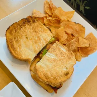 a sandwich and chips on a plate