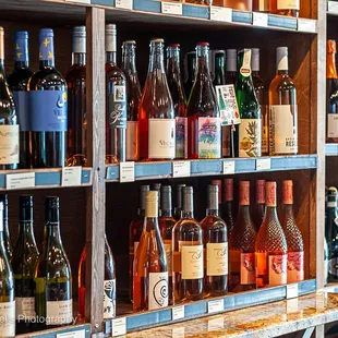 a shelf full of wine bottles