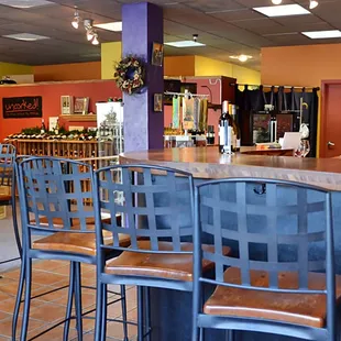 a restaurant with a bar and chairs