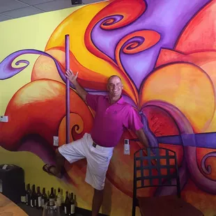 Robs guest pouring at Uncorked! Doesn't he match the decor perfectly? Maybe. He should pour more and drink less!