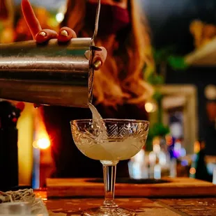 a person pouring a drink