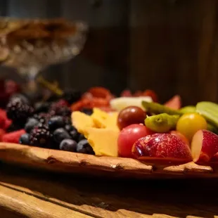 a wooden platter of fruit