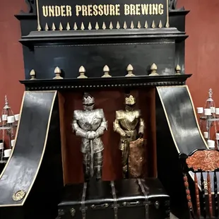 two knights standing in front of a fire place