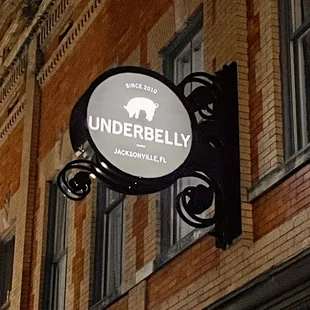 a black and white sign on a brick building