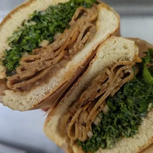 The Vegan Dodge with house made seitan, marinated kale, caramelized onions, red onions and tahini garlic spread.