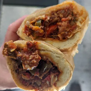 The Italian Sausage Sandwich with provolone and parmesan cheese, peppers, onions and tomato sauce.