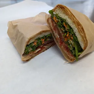 The BLTish.  Pepper bacon, tomato jam provolone cheese and arugula slaw on white bread.