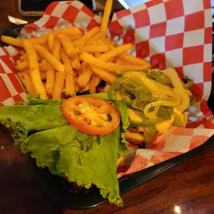 Cheeseburger with grilled peppers, onions and fries