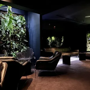 a man sitting on a couch in a dark room