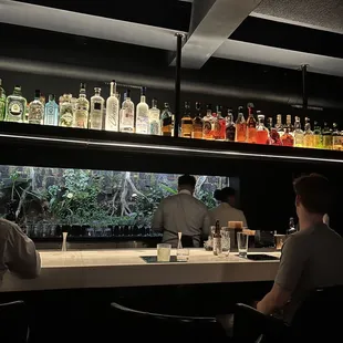 two men sitting at a bar