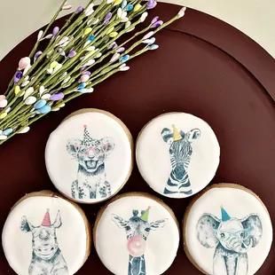 four decorated cookies on a plate