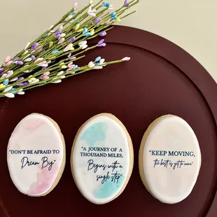three decorated cookies on a plate