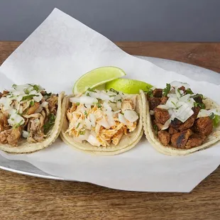 three tacoss on a plate