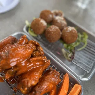a tray of wings and carrots