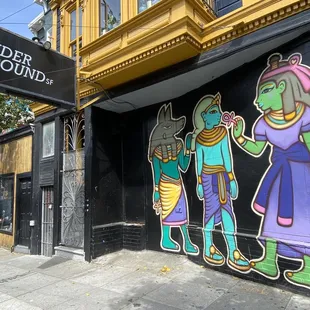 a mural on a building on a street corner