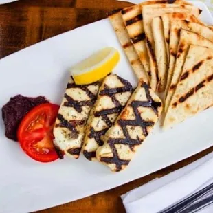 Grilled Halloumi Olive caponata, tomato, cucumbers herbs, pita.