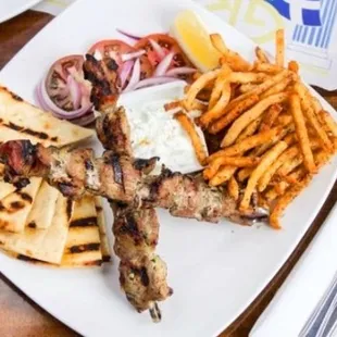 Marinated pork skewers, served with tomato, onions, pita, Kennebec French fries ,tzatziki dip.