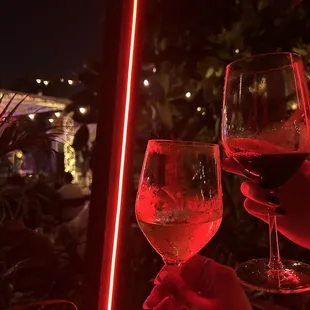 two people toasting with wine glasses