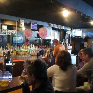 a group of people sitting at a bar
