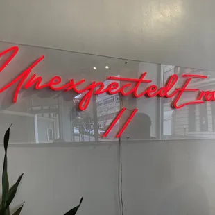 a neon sign on the wall