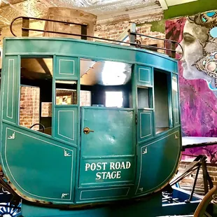 a green horse drawn carriage