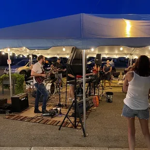 a band playing under a tent