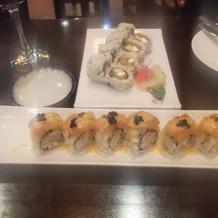 a plate of sushi and a glass of wine
