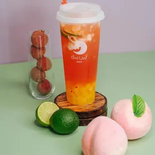 a glass of iced tea with a straw and a straw and some fruit