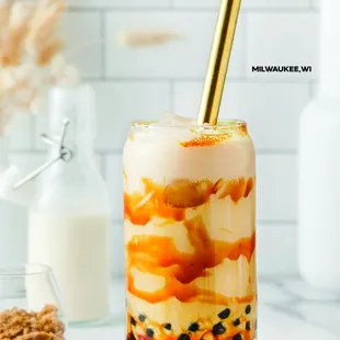 a glass of soft opening tea with a straw