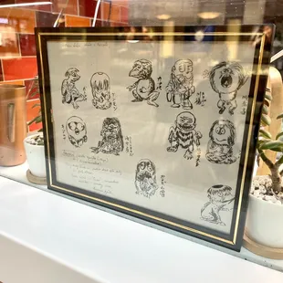 A cute sketch cartoon displayed near the pick up window