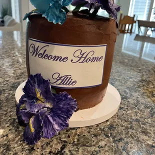 a welcome home sign and flowers
