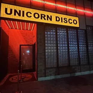 a neon sign in front of a building
