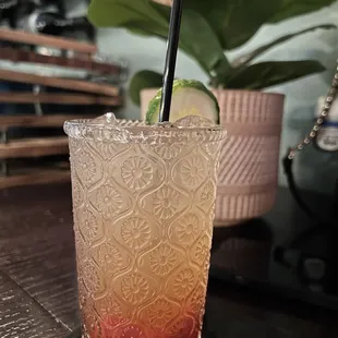 a tall glass with a drink in it