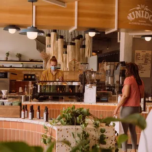 a man and a woman working in a coffee shop