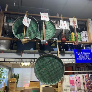 a variety of baskets hanging from the ceiling