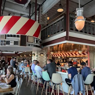 people sitting at tables in a restaurant