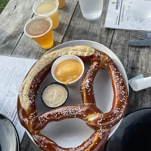 Fresh pretzel with cheese and mustard dipping sauces