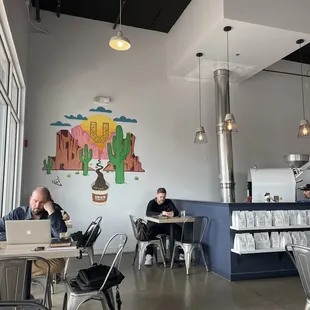 people sitting at tables in a coffee shop