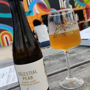 a glass of beer and a bottle of beer