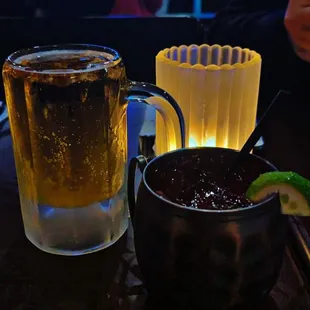 two glasses of beer and a bowl of chili