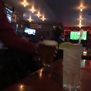 a person serving a drink at a bar